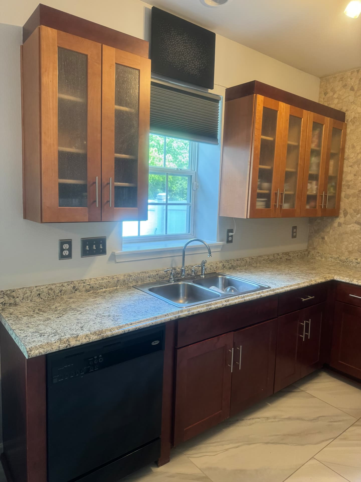 Kitchen after remodel with cherry cabinetry, granite counters, stone backsplash and marble tile floor